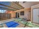 Private outdoor patio area featuring a slat roof and patio access at 4036 Nightingale Ct, Las Vegas, NV 89107