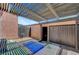 Private outdoor patio with slat roof and shaded sitting area at 4036 Nightingale Ct, Las Vegas, NV 89107