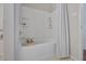 Bathroom featuring a shower-tub combo with tiled walls and built-in shelves at 4458 El Quinta Ct, Las Vegas, NV 89121