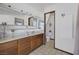 Bright bathroom with double sinks, a large mirror, and vanity with lots of storage space at 4458 El Quinta Ct, Las Vegas, NV 89121