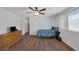 Bedroom with hardwood floors, a ceiling fan, and natural light from the window at 4458 El Quinta Ct, Las Vegas, NV 89121