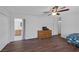 Bedroom with hardwood floors, a ceiling fan, and an ensuite bathroom at 4458 El Quinta Ct, Las Vegas, NV 89121