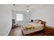Comfortable bedroom with ceiling fan, natural light, and wood laminate flooring at 4458 El Quinta Ct, Las Vegas, NV 89121