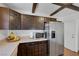 Well-maintained kitchen with dark cabinets, stainless steel appliances and light countertops at 4458 El Quinta Ct, Las Vegas, NV 89121