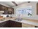 Kitchen featuring dark wood cabinets, and a double sink at 4458 El Quinta Ct, Las Vegas, NV 89121