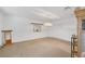 Spacious living room with carpet floors, pendant lights, and natural lighting at 4458 El Quinta Ct, Las Vegas, NV 89121