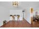 Bright living room with hardwood floors and space for dining, adjacent to the living area at 4458 El Quinta Ct, Las Vegas, NV 89121