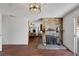 Spacious living room featuring a stone fireplace, hardwood floors, and open layout at 4458 El Quinta Ct, Las Vegas, NV 89121