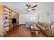 Cozy living room featuring a ceiling fan, hardwood floors, and comfortable seating at 4458 El Quinta Ct, Las Vegas, NV 89121