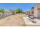 This backyard is spacious and features a patio with chairs and a table at 4784 El Escorial Dr, Las Vegas, NV 89121