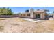 This backyard is spacious and features a patio with chairs and a table at 4784 El Escorial Dr, Las Vegas, NV 89121