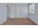 This bedroom offers ample closet space, a window, and neutral-toned walls and carpeting at 4784 El Escorial Dr, Las Vegas, NV 89121