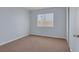 This bedroom features a window, neutral-toned walls and carpeting, and a closet at 4784 El Escorial Dr, Las Vegas, NV 89121