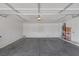 The garage is spacious and has shelving for storage and an automatic garage door opener at 4784 El Escorial Dr, Las Vegas, NV 89121