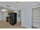 Well-lit kitchen showcasing black refrigerator, wooden cabinets, and a pantry, with a laundry room nearby at 4784 El Escorial Dr, Las Vegas, NV 89121
