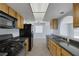 Efficient kitchen featuring granite countertops, modern appliances, and a view to the living area at 4784 El Escorial Dr, Las Vegas, NV 89121