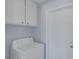 The laundry room features a washing machine, overhead cabinets and access to the outside at 4784 El Escorial Dr, Las Vegas, NV 89121
