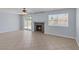 Living room with a fireplace, sliding glass doors to the patio, large window and ceiling fan at 4784 El Escorial Dr, Las Vegas, NV 89121