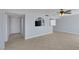 Bright living room with tile flooring, a ceiling fan, and open access to the kitchen area at 4784 El Escorial Dr, Las Vegas, NV 89121