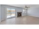 Spacious living area with tile floors, fireplace, a ceiling fan, and sliding glass doors to patio at 4784 El Escorial Dr, Las Vegas, NV 89121