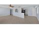 Spacious living room featuring tile flooring, a ceiling fan, and easy access to the kitchen at 4784 El Escorial Dr, Las Vegas, NV 89121