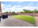 Large backyard featuring a well-maintained lawn, paver patio, and a BBQ grill for entertaining guests at 5009 Peaceful Pond Ave, Las Vegas, NV 89131