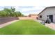 Spacious backyard with artificial grass, a paved patio area, and perimeter block wall at 5009 Peaceful Pond Ave, Las Vegas, NV 89131