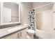 Updated bathroom features vanity with solid surface countertops and shower/tub at 5009 Peaceful Pond Ave, Las Vegas, NV 89131