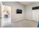 Open bedroom featuring soft carpets, neutral paint, and a view into the living area at 5009 Peaceful Pond Ave, Las Vegas, NV 89131