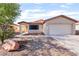 Charming single-story home with a well-manicured front yard and two-car garage at 5009 Peaceful Pond Ave, Las Vegas, NV 89131