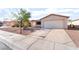 Single-story home features a large driveway, xeriscape front yard, and an attached two car garage at 5009 Peaceful Pond Ave, Las Vegas, NV 89131