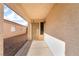 Covered front porch features a decorative security door with adjacent sidelight on a sunny day at 5009 Peaceful Pond Ave, Las Vegas, NV 89131