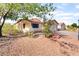 Single-story house featuring a xeriscaped front yard, mature tree, and well-manicured shrubbery at 5009 Peaceful Pond Ave, Las Vegas, NV 89131