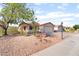 Single story home with xeriscaped front yard and well maintained lawn and charming desert landscaping at 5009 Peaceful Pond Ave, Las Vegas, NV 89131