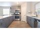 Updated kitchen with quartz countertops, gray cabinets, stainless steel appliances, and modern lighting at 5009 Peaceful Pond Ave, Las Vegas, NV 89131