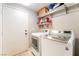Laundry room with large capacity front load washer and dryer, plus storage at 5009 Peaceful Pond Ave, Las Vegas, NV 89131
