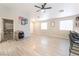 Bright living room featuring an open layout, wood-style flooring, and access to multiple rooms at 5009 Peaceful Pond Ave, Las Vegas, NV 89131