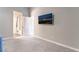 Open primary bedroom featuring soft carpeting and a view into the attached ensuite bathroom at 5009 Peaceful Pond Ave, Las Vegas, NV 89131
