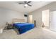 Large primary bedroom offering soft carpeting, a ceiling fan, and ensuite bathroom access at 5009 Peaceful Pond Ave, Las Vegas, NV 89131