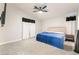 Spacious primary bedroom features plush carpeting, a modern ceiling fan, and contemporary decor at 5009 Peaceful Pond Ave, Las Vegas, NV 89131