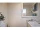 Small utility sink with a mirror and textured walls offer practical functionality at 5093 Sun Valley Dr, Las Vegas, NV 89122