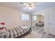 Cozy bedroom with ceiling fan, large window, and mirrored closet doors is brightly lit and comfortable at 5093 Sun Valley Dr, Las Vegas, NV 89122