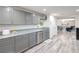 Modern kitchen with gray cabinets, stainless steel appliances, granite countertops, and wood-look floors at 5093 Sun Valley Dr, Las Vegas, NV 89122