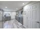 Bright kitchen featuring gray cabinets, modern appliances, ample counter space and wood look flooring at 5093 Sun Valley Dr, Las Vegas, NV 89122