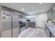 Updated kitchen featuring stainless steel appliances, gray cabinetry, and bright lighting at 5093 Sun Valley Dr, Las Vegas, NV 89122
