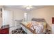 Bright main bedroom with ceiling fan, dresser, wood laminate floors, closet and interior access at 5093 Sun Valley Dr, Las Vegas, NV 89122