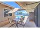 Outdoor dining on the covered patio, featuring an umbrella, dining set and view of the pool at 5093 Sun Valley Dr, Las Vegas, NV 89122