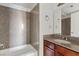 Bathroom featuring granite countertop, a large mirror, and granite wall in the shower and bath at 5200 Indian River Dr # 301, Las Vegas, NV 89103