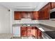 This kitchen features wooden cabinets, a stainless steel microwave, and a white dishwasher at 5200 Indian River Dr # 301, Las Vegas, NV 89103