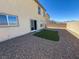 The backyard features low-maintenance gravel landscaping and a small patch of artificial turf at 5308 Hollyridge St, North Las Vegas, NV 89081